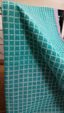  Close-up view of the bold blue check block print design on the soft cotton saree body.