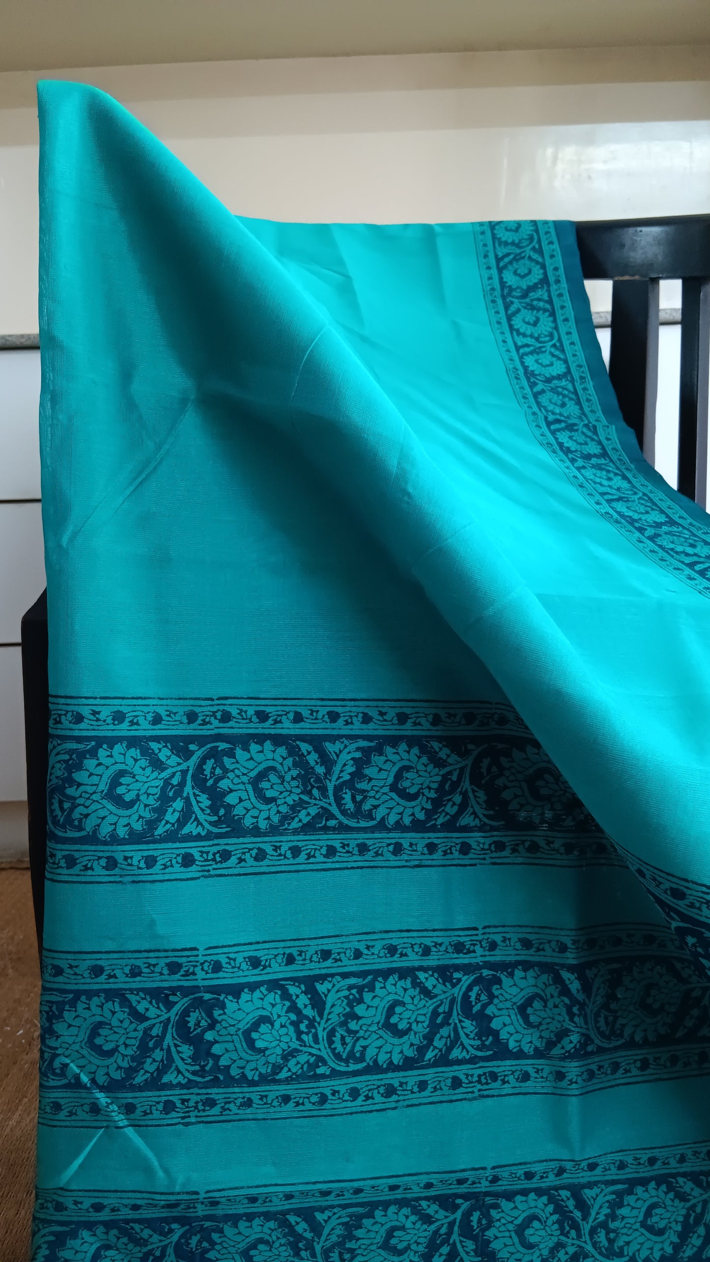 Close up view the plain body of a simple blue daily wear silk cotton saree