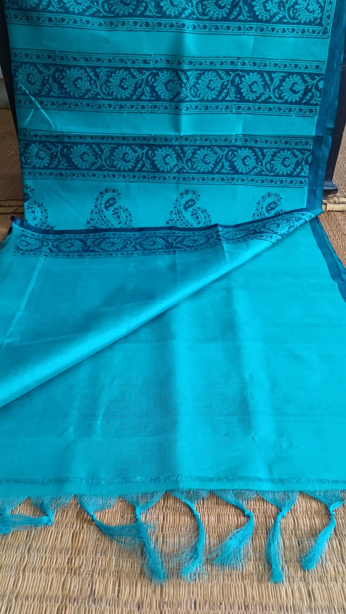 View from the top of the plain blouse of a simple, hand woven, blue, daily wear, silk cotton saree