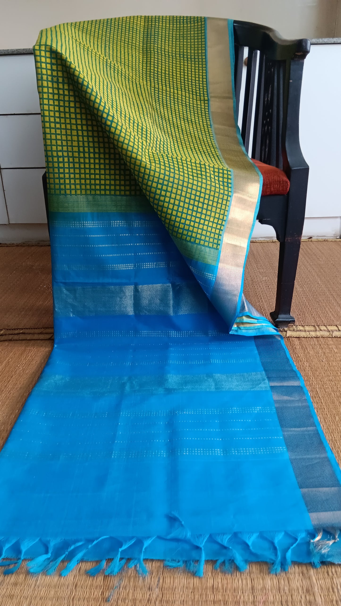 Green handloom office wear silk cotton saree with blue pallu hand block printed with checks on the body