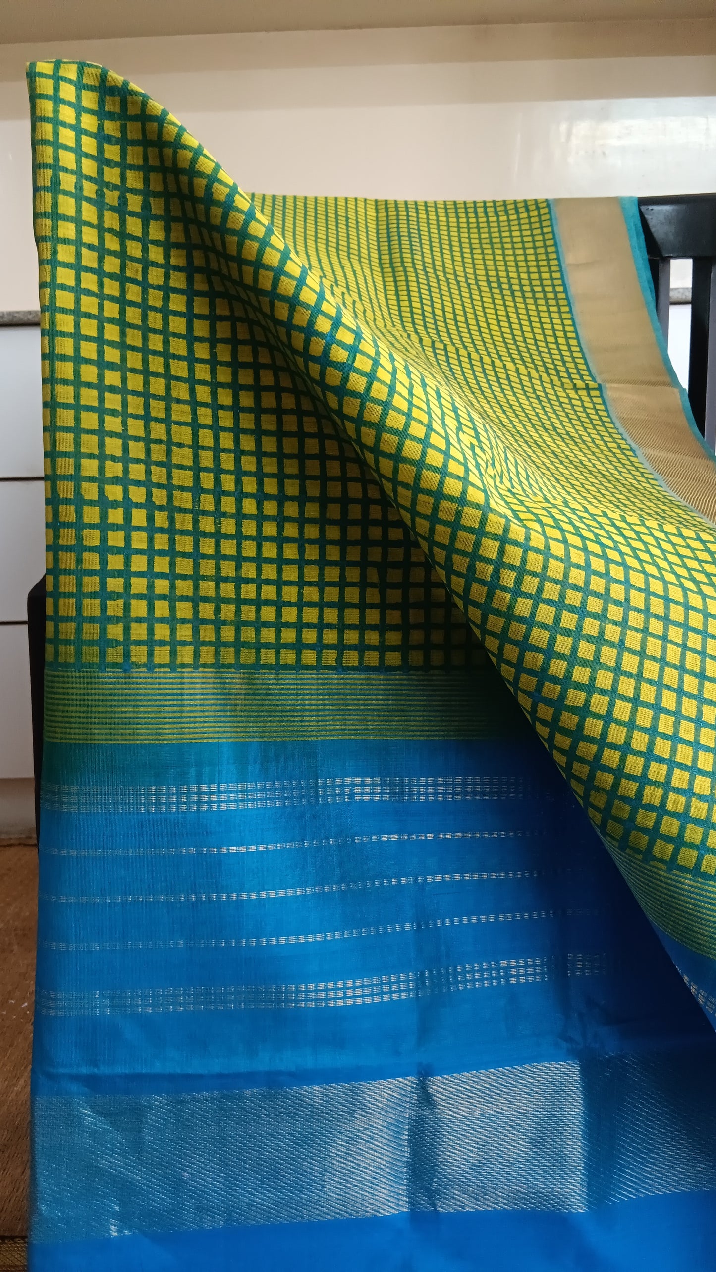 Close up view of the checks hand block printed on the body of a simple function wear silk cotton saree