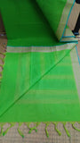 Plain green cotton blouse included with the saree.