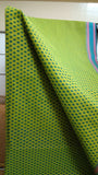 Close-up view of the eye-catching geometric pattern on the bright green cotton saree body