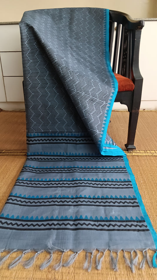 Grey handloom office wear silk cotton saree with blue border hand block printed with bold geometric patterns on the body