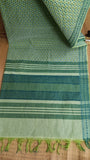 Top view of the saree's pallu in light green cotton, showcasing a continuation of the blue and green geometric print.
