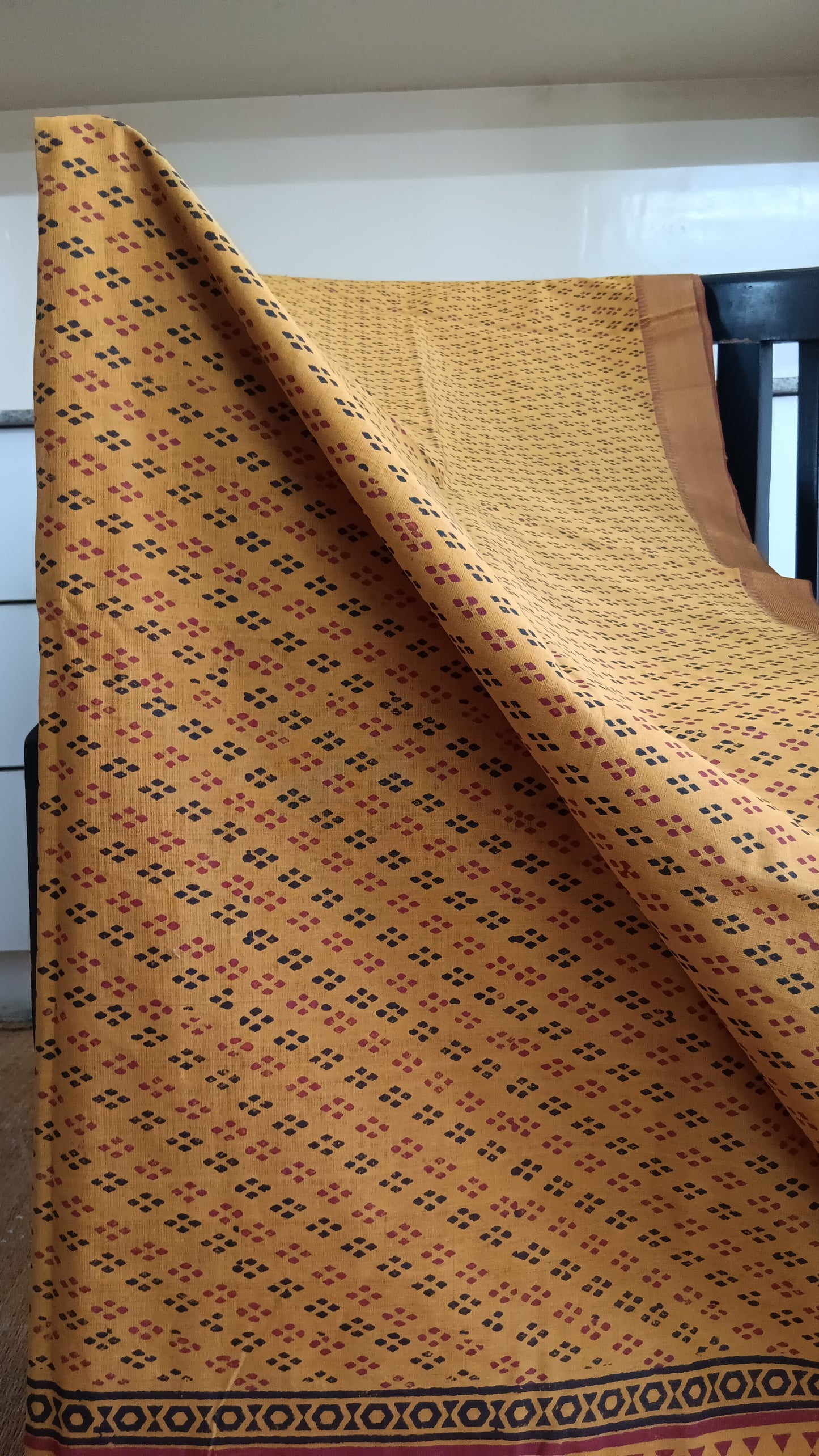 Close-up of geometric pattern block printed on the body of a function wear Mangalgiri cotton saree