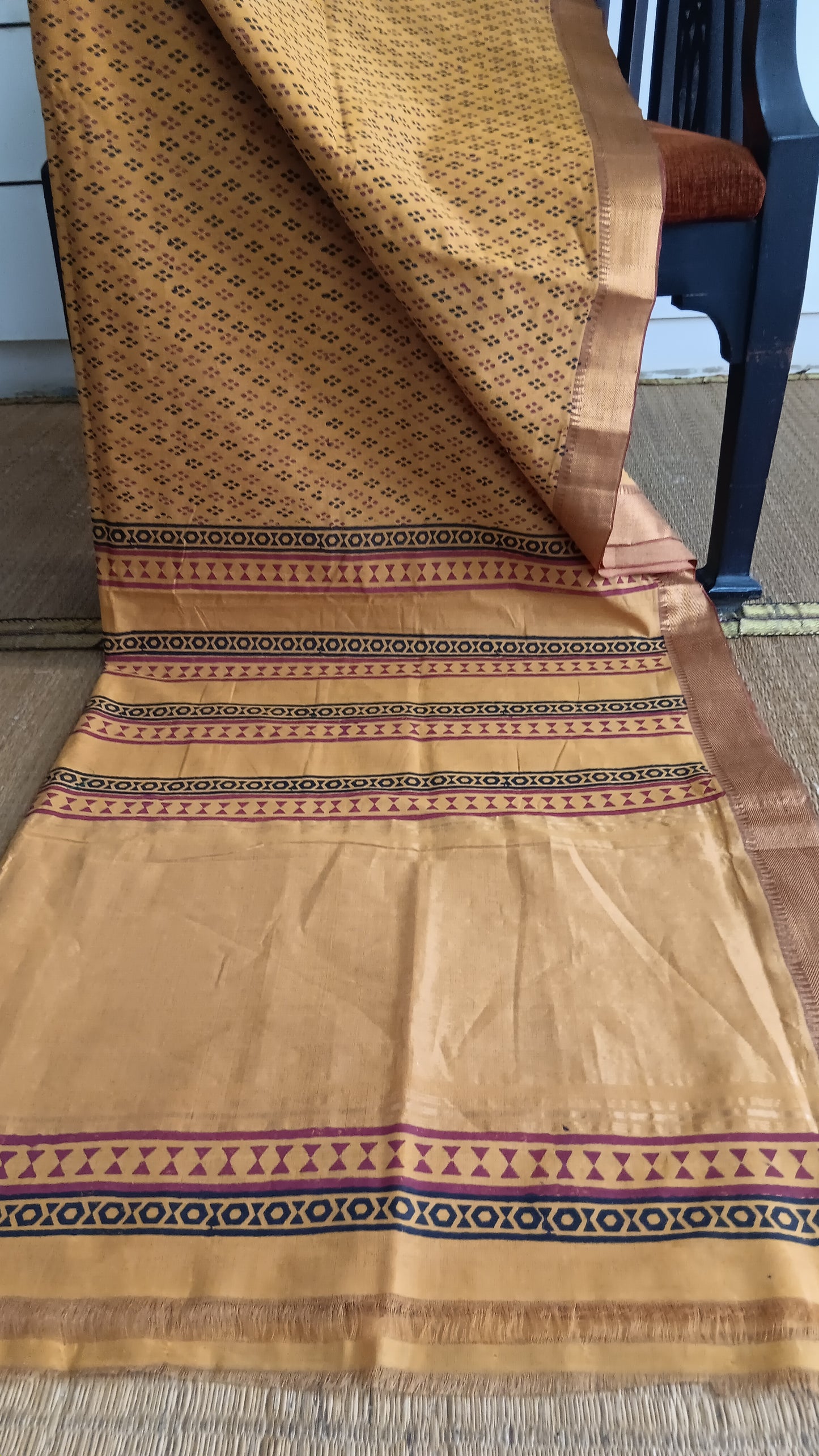 View from the top of the printed pallu of a Mustard function wear Mangalgiri cotton saree