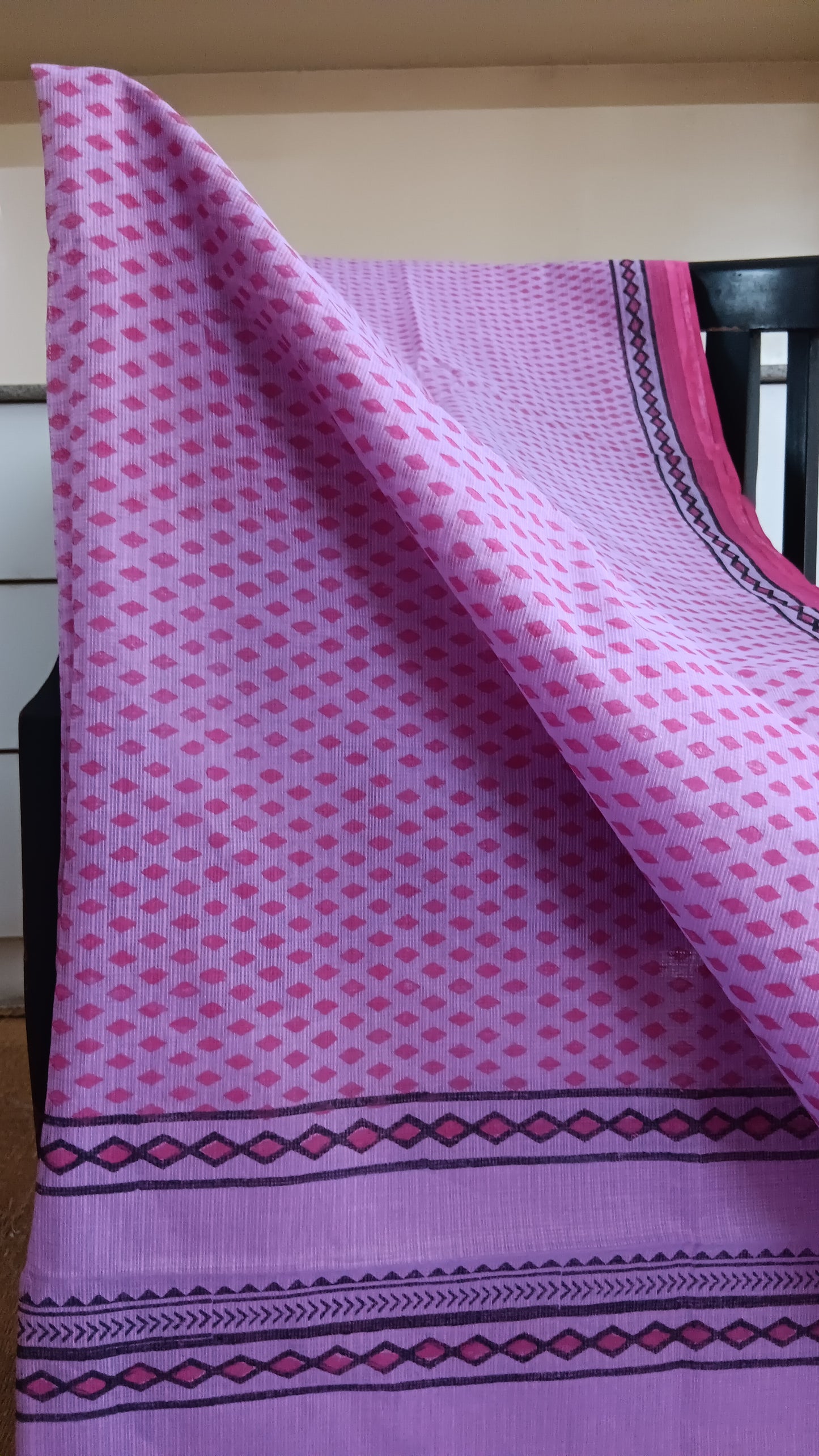 Close up of the simple geometric patterns hand block printed on the body of a daily wear light-weight kota cotton saree