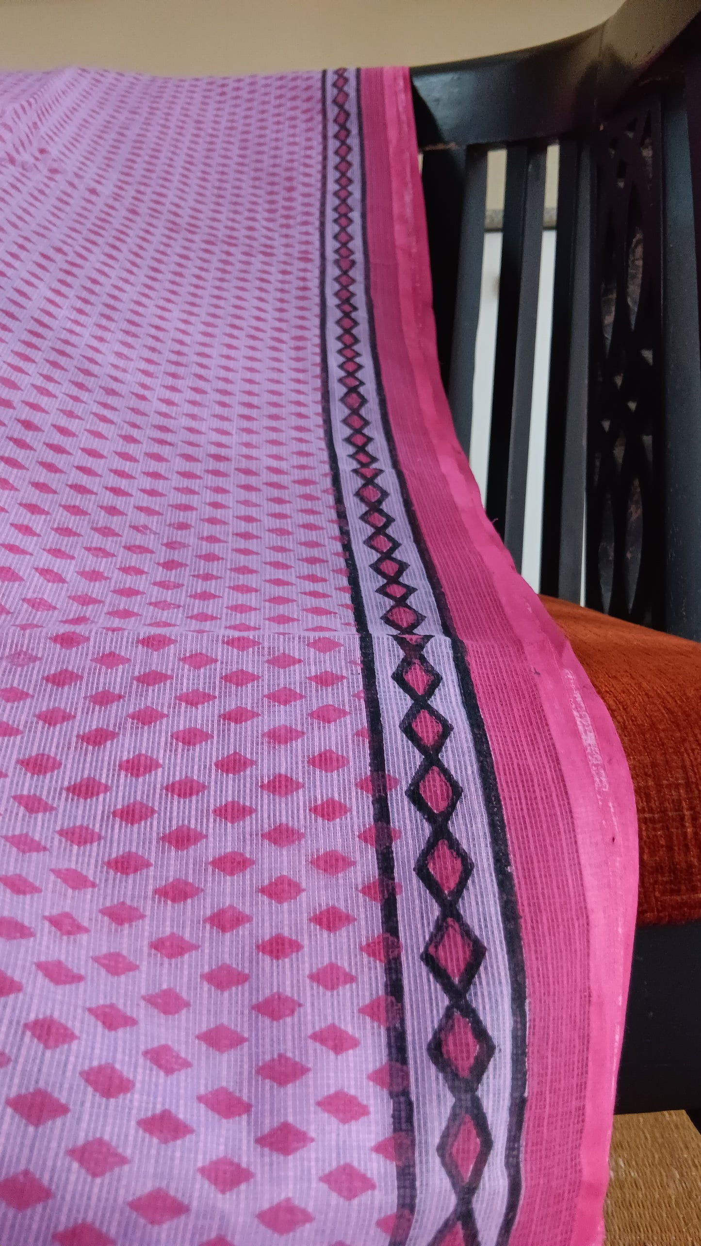 Close up of the simple geometric patterns hand block printed on the border of a daily wear light-weight kota cotton saree