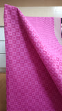Close-up view of the geometric pattern printed on the soft pink cotton saree body