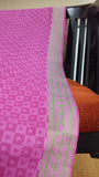 Eye-catching green thread border adds a touch of sophistication to the pink cotton saree.