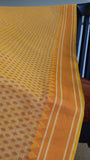 Matching yellow thread border complements the cheerful yellow cotton saree