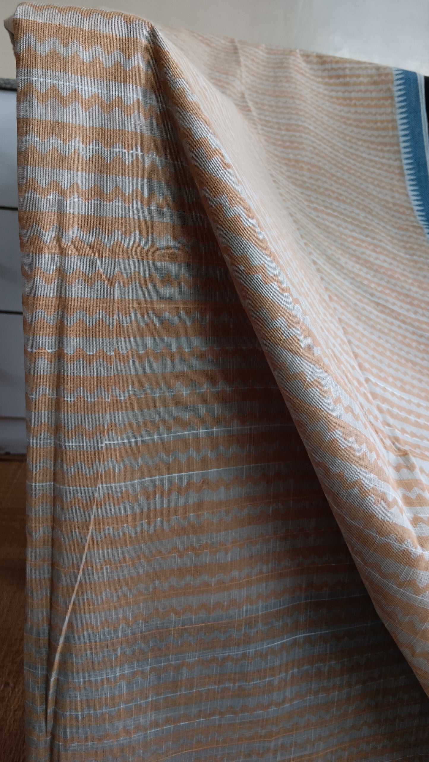 close up view of the geometric patterns block printed on the body of a daily wear cotton saree