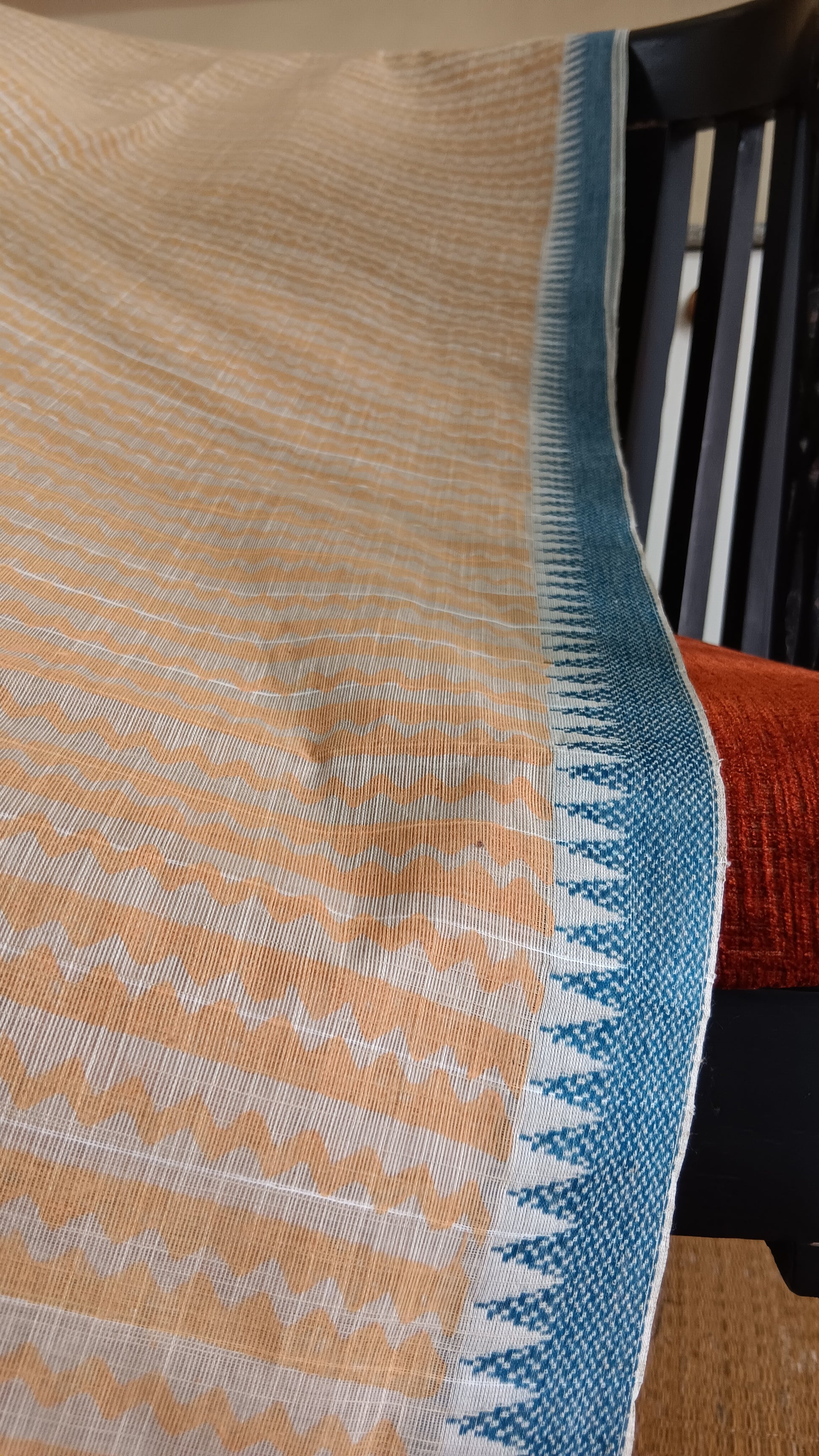 close up view of the blue woven border of a daily wear cotton saree