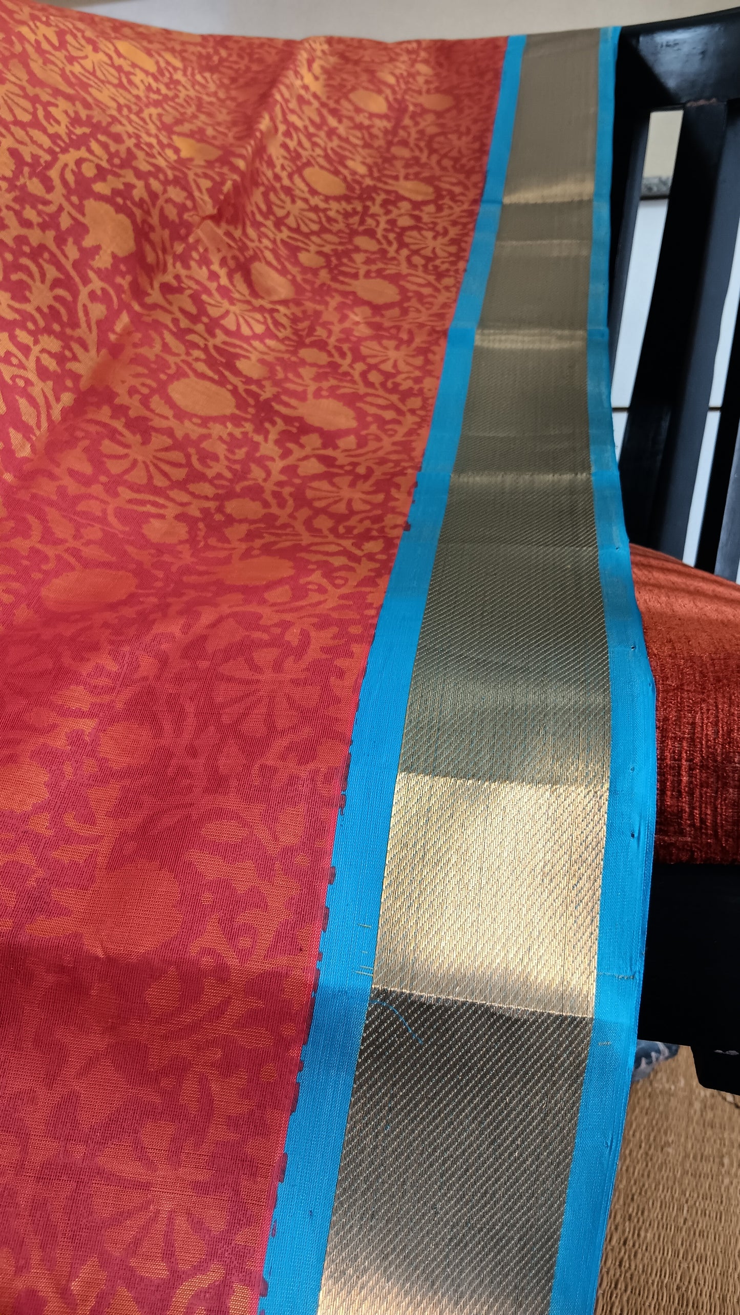 Close up view of the zari border of a hand woven and block printed silk cotton saree