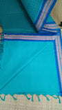Plain turquoise cotton blouse included with the saree.