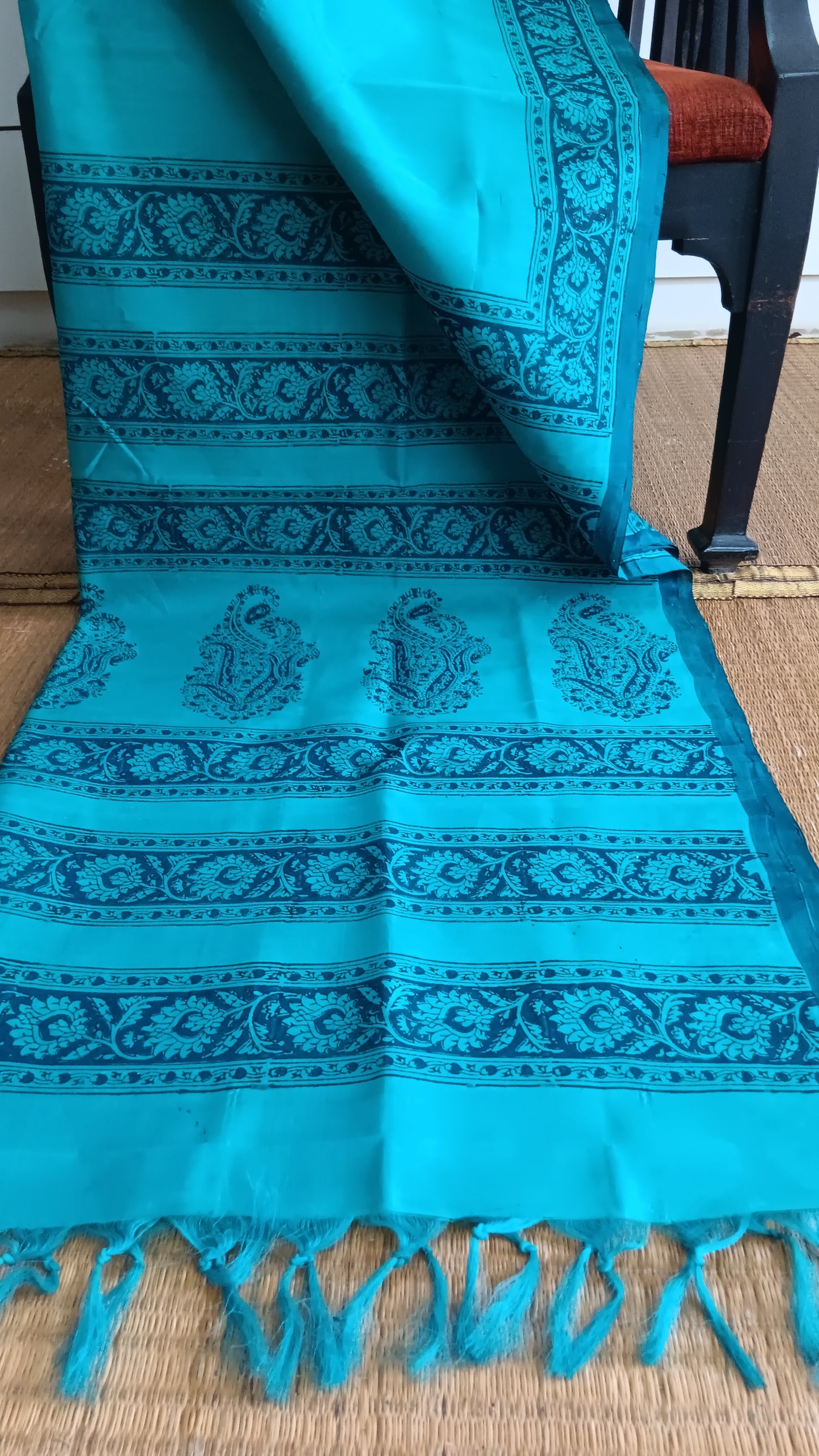 View from the top of the block printed pallu of  a simple, hand woven, blue, daily wear, silk cotton saree