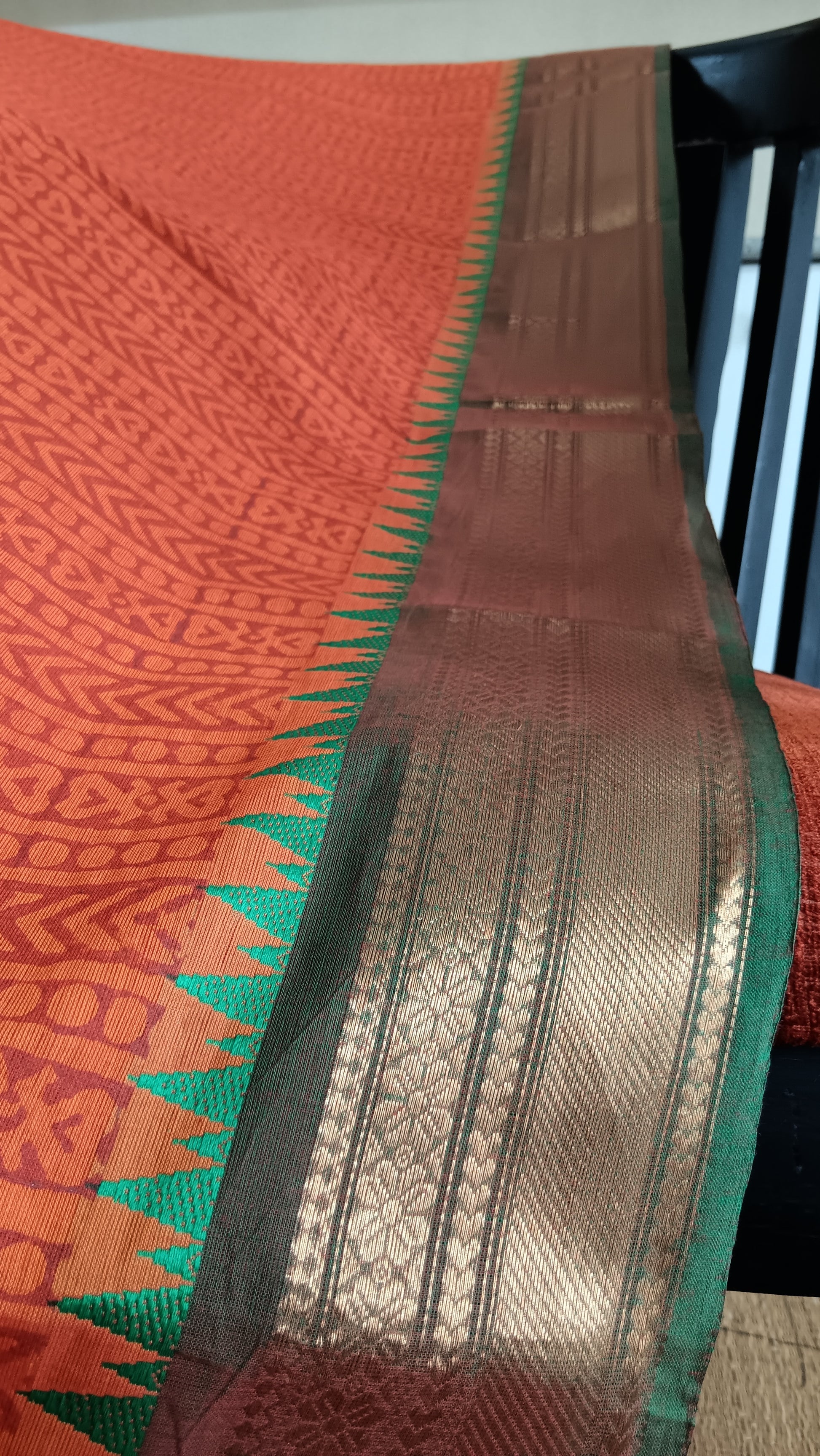 Close up view of the woven zari border of a function wear cotton saree 