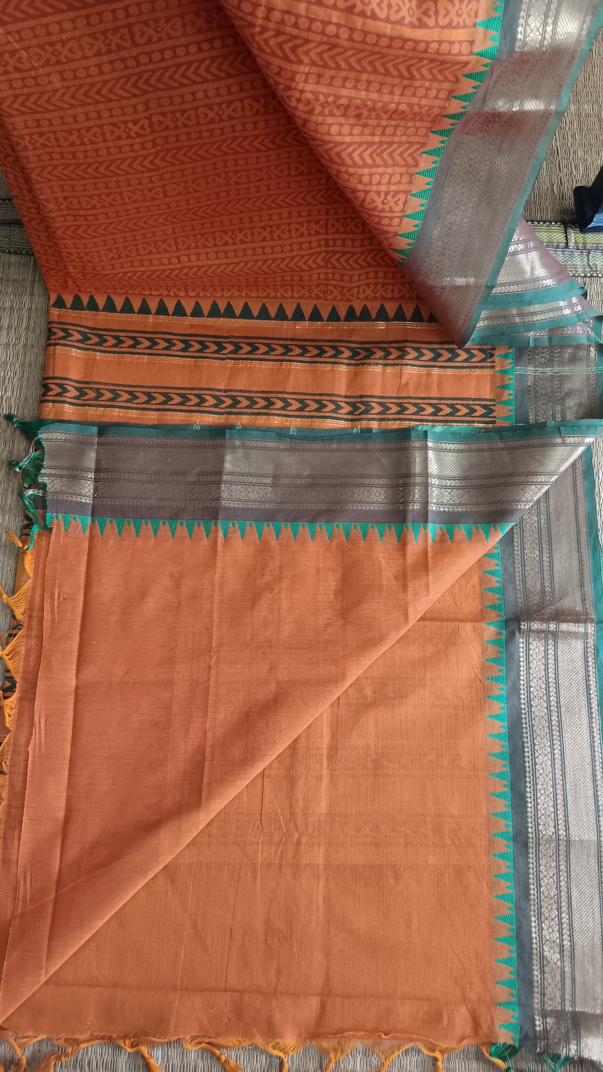 View from the top of the plain rust blouse of a function wear south cotton saree