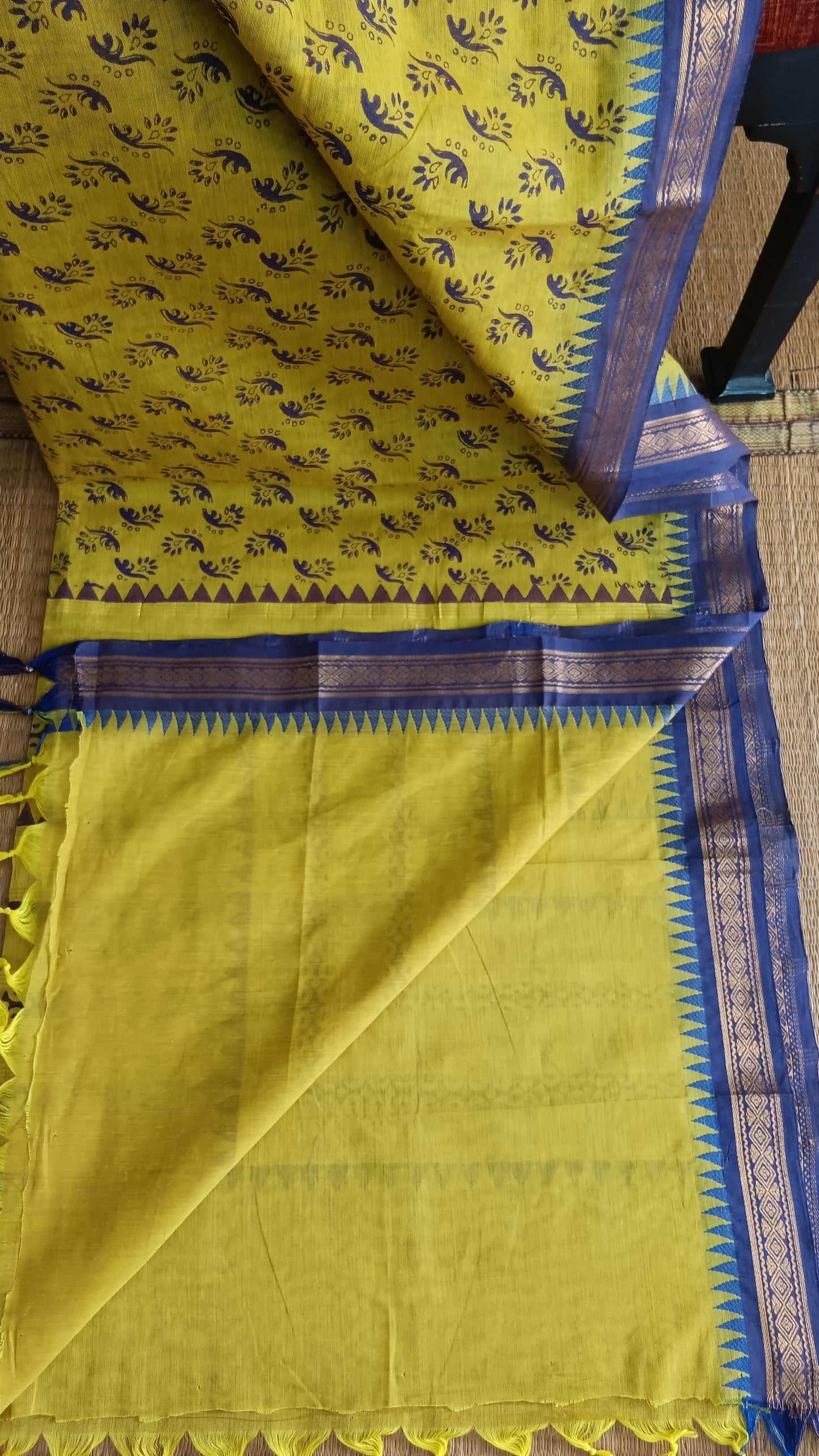 View from the top of the plain yellow blouse of funtion wear cotton saree