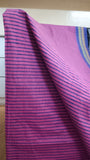 Close-up view of bold blue stripes block printed on the pink cotton saree body.