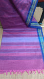 Top view of the saree's pallu in pink cotton, featuring a continuation of the blue stripes and a touch of the dark blue border.