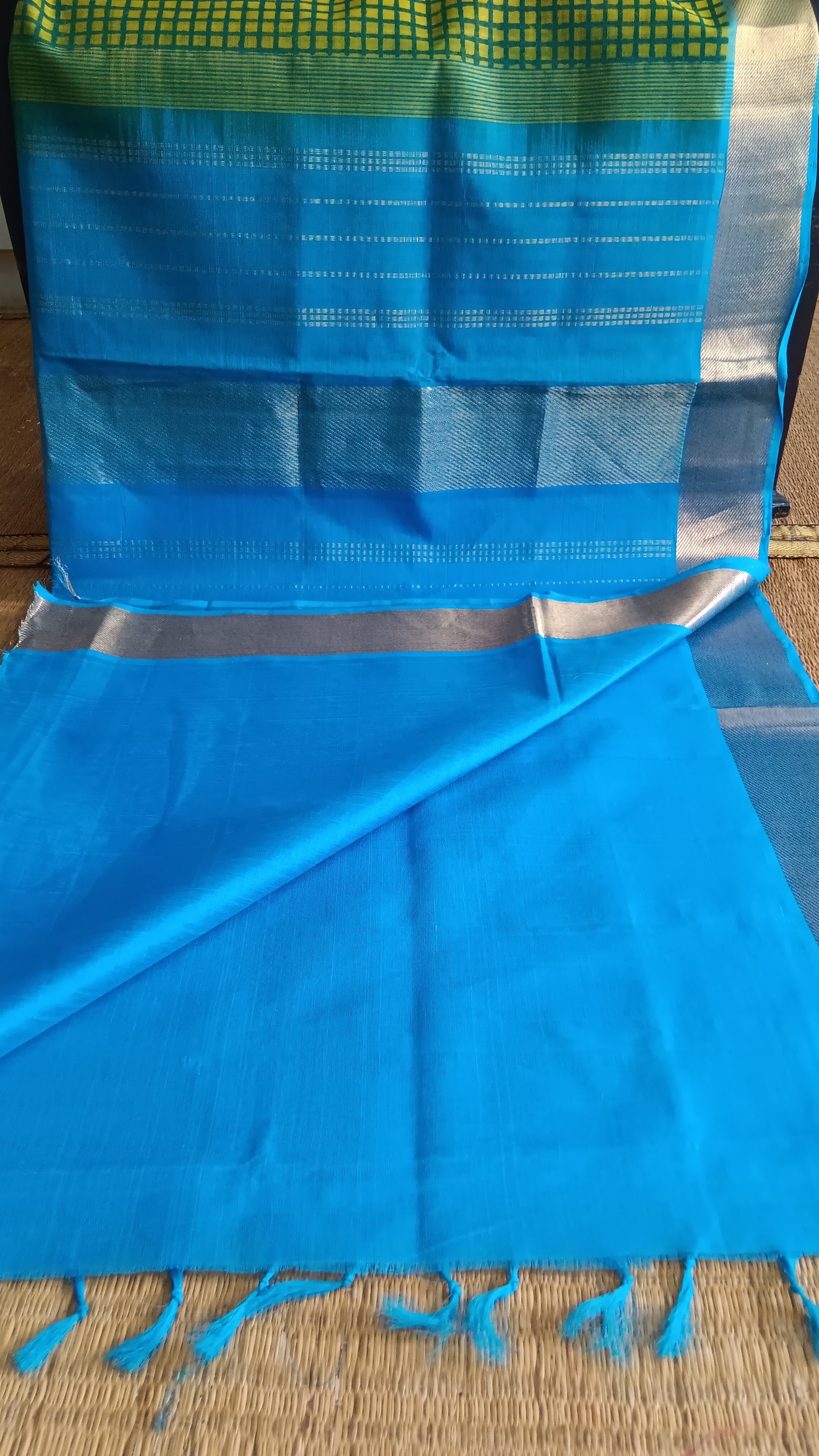 View from the top of the plain blouse of  a simple, hand woven, function wear, silk cotton saree