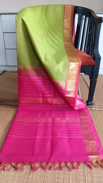 Handwoven silk cotton saree in vibrant green with geometric block print and pink pallu
