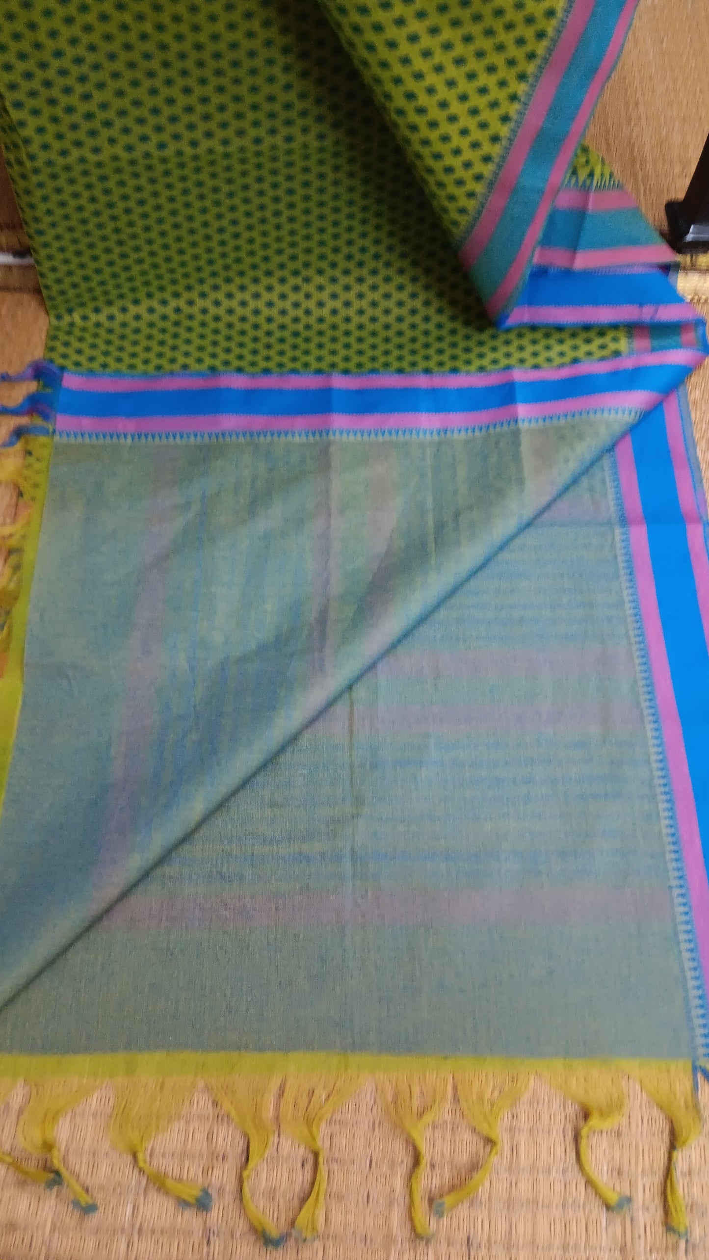 Plain blue blouse included to complete your look in this green cotton saree 