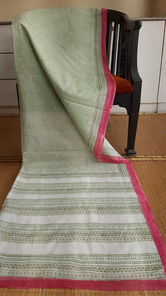 Full view of a kota cottton saree with geometric patterns block printed in green on the body and a pink border