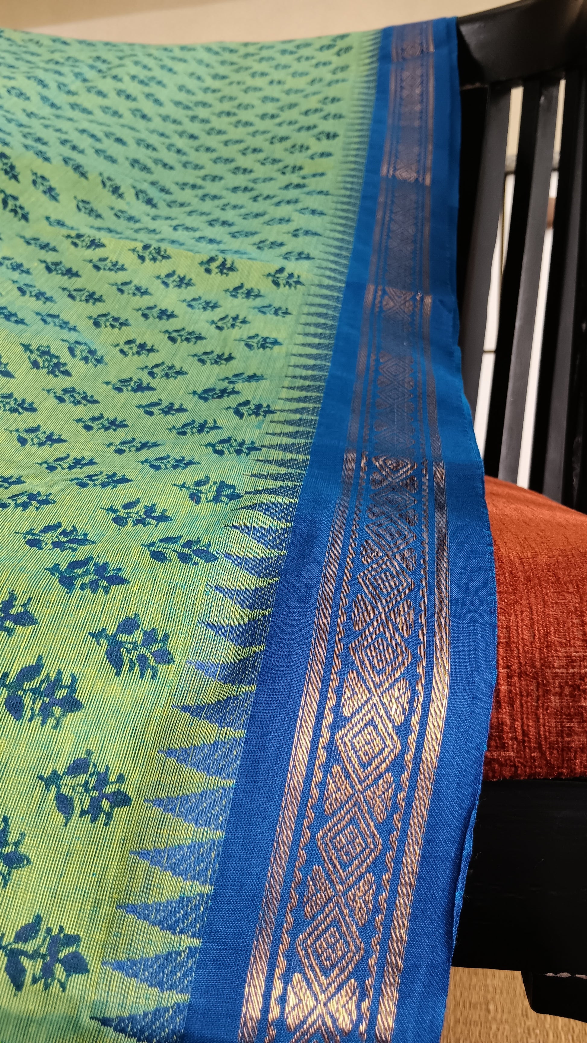Close up view of the woven zari border of a function wear saree from south India