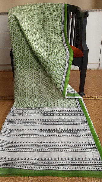 Full view of a kota cotton saree hand block printed with bold geometric prints in green on the body
