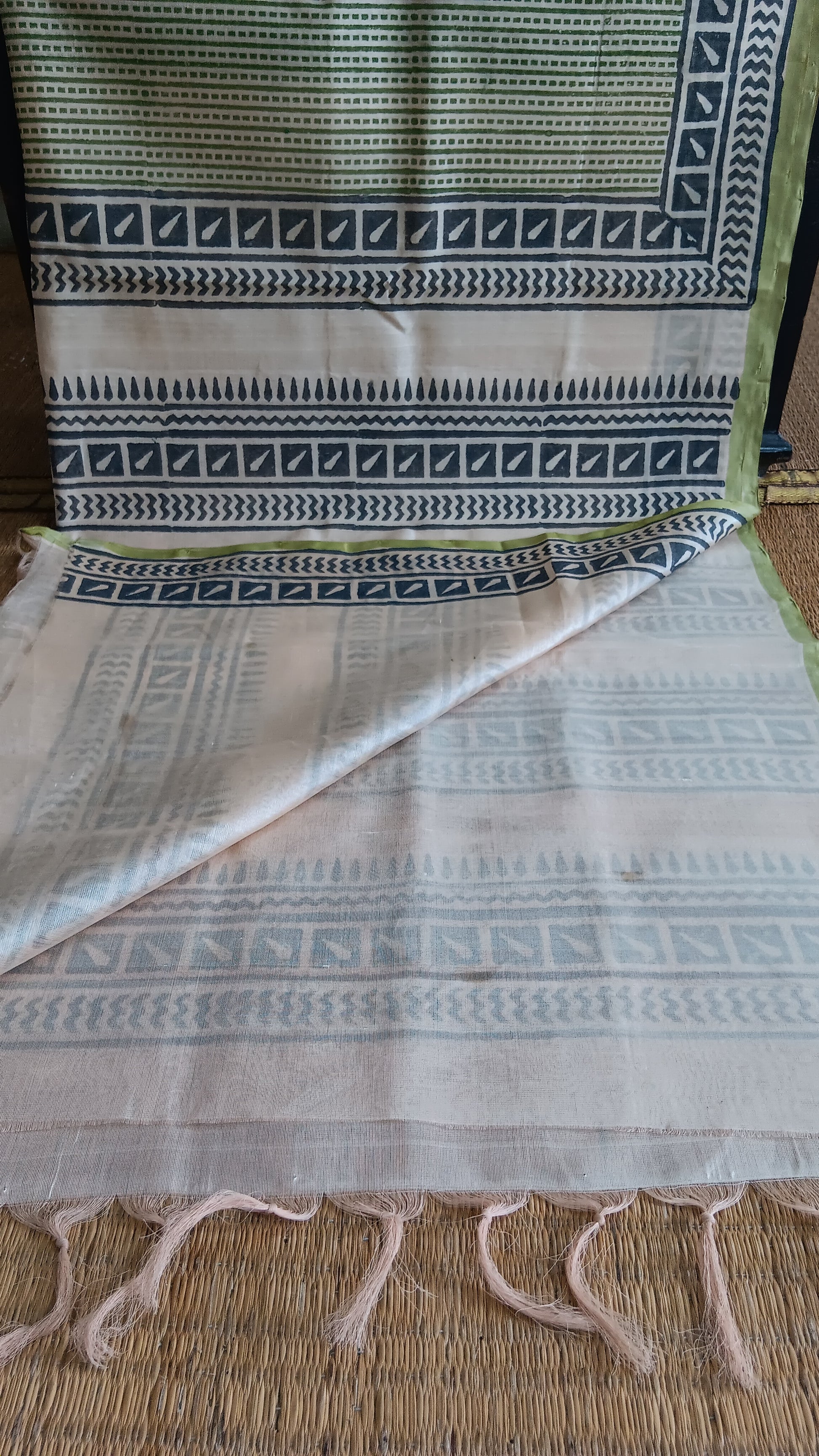 View from the top of the plain blouse of  a simple, hand woven, grey, daily wear, silk cotton saree