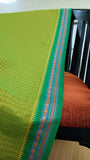 Close-up of the saree's elegant woven thread border, showcasing traditional craftsmanship.