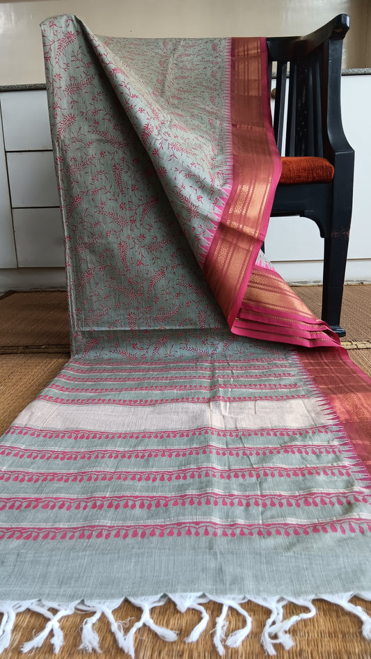 Grey cotton saree with pink zari border. 