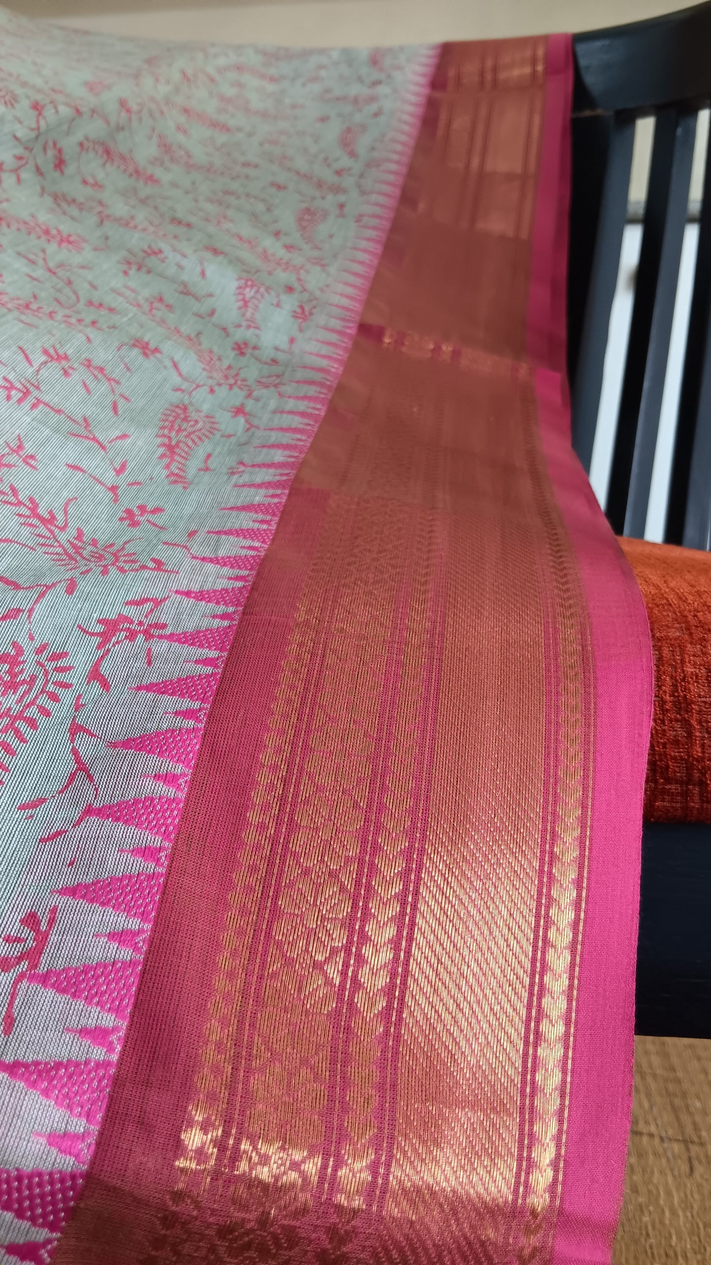 Close up view of the woven zari border of a function wear cotton saree