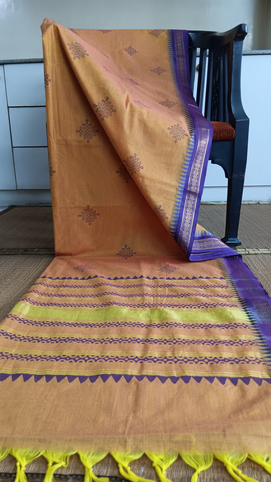 Cotton saree with zari border woven in Tamil Nadu and hand block printed with kolam motifs on the body