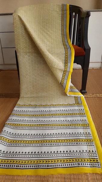 Full view of black and yellow block printed kota cotton saree for daily use draped on a wooden chair