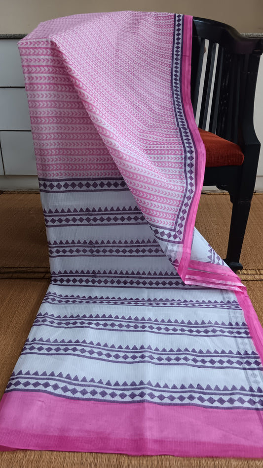 White Kota cotton saree with hand block printed geometric patterns in light pink on the body and purple on the border and pallu.  pen_spark