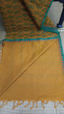Plain mustard cotton blouse included with the saree.