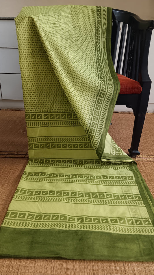 Mustard Kota cotton saree with hand block printed olive green geometric patterns on the body and pallu.