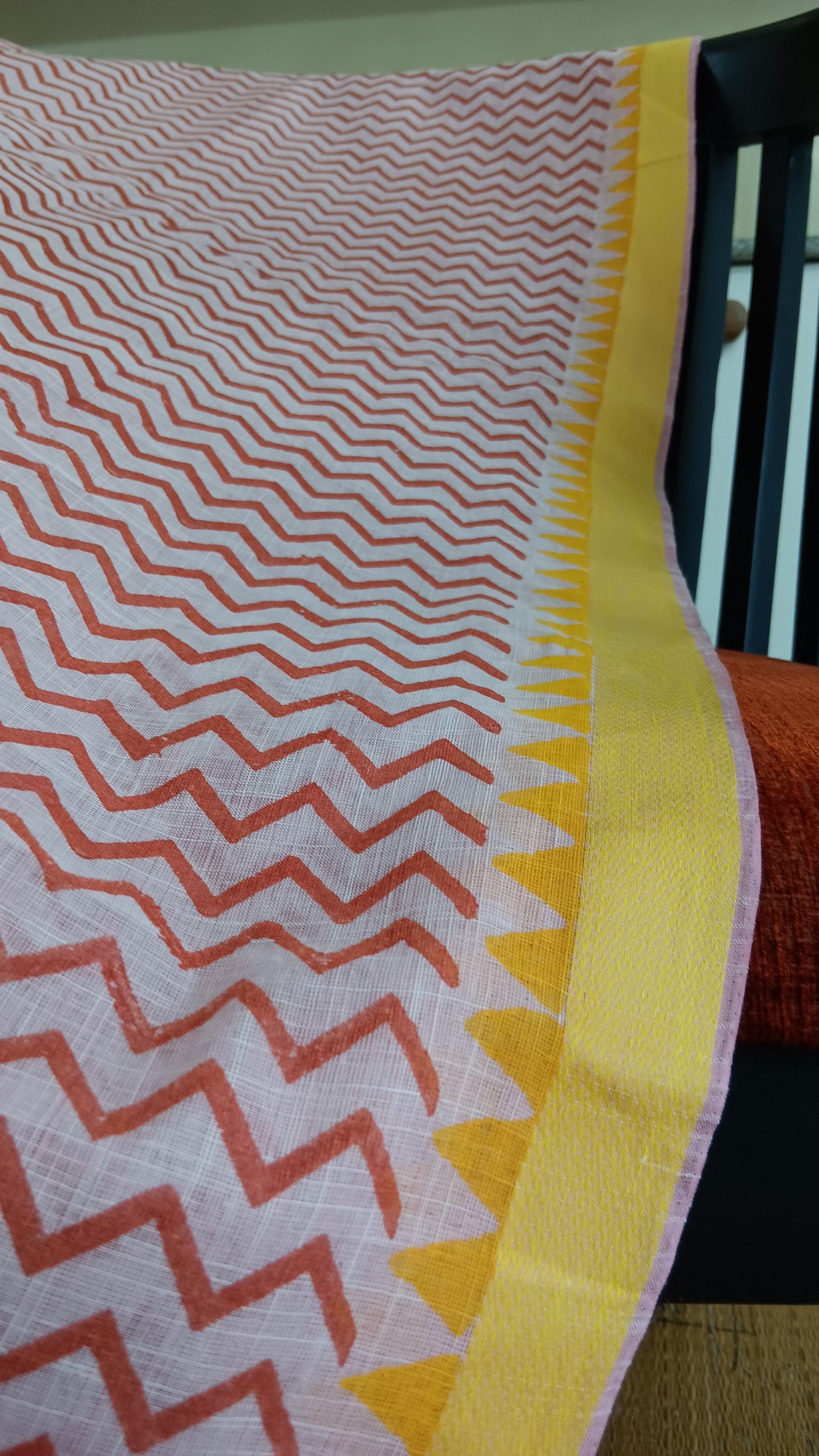 Close up view of the yellow border of a cotton saree for daily use