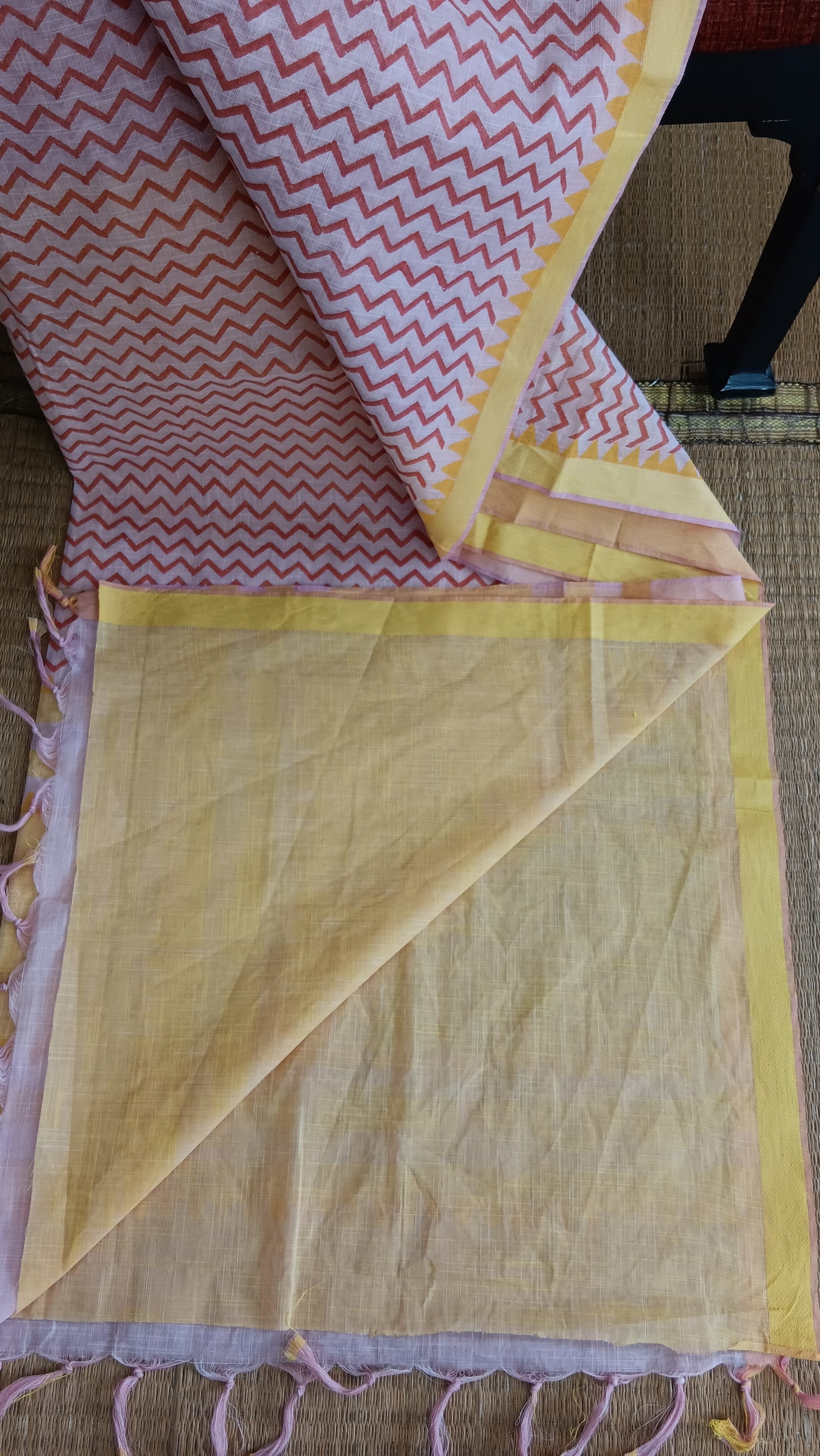 view from the top of  the plain yellow blouse of a cotton saree for daily use