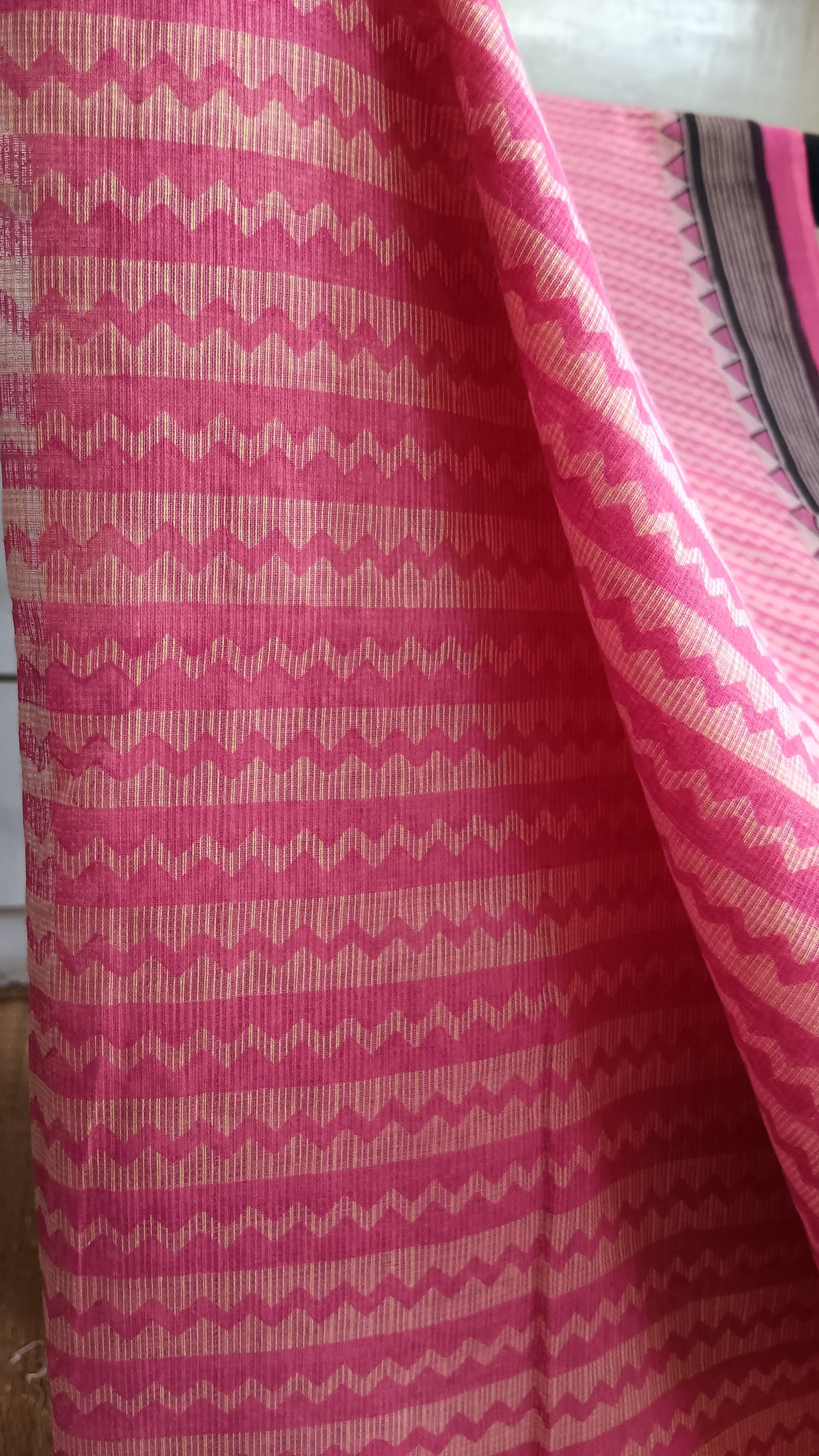 Close up view of the geometric pattern block printed on the body of a pink daily wear kota cotton saree