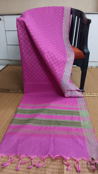 Confidence & Grace: Pink Cotton Saree with Green Border (Work & Home). This captivating pink cotton saree features a contrasting green border and geometric prints, perfect for feeling confident and graceful at work or home.