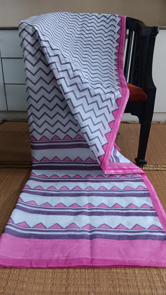 Pink Kota cotton saree with hand block printed purple chevrons on the body, pink border and pallu featuring temple motifs.  pen_spark
