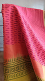 Close-up of geometric block print in pink on handwoven pink silk cotton saree body