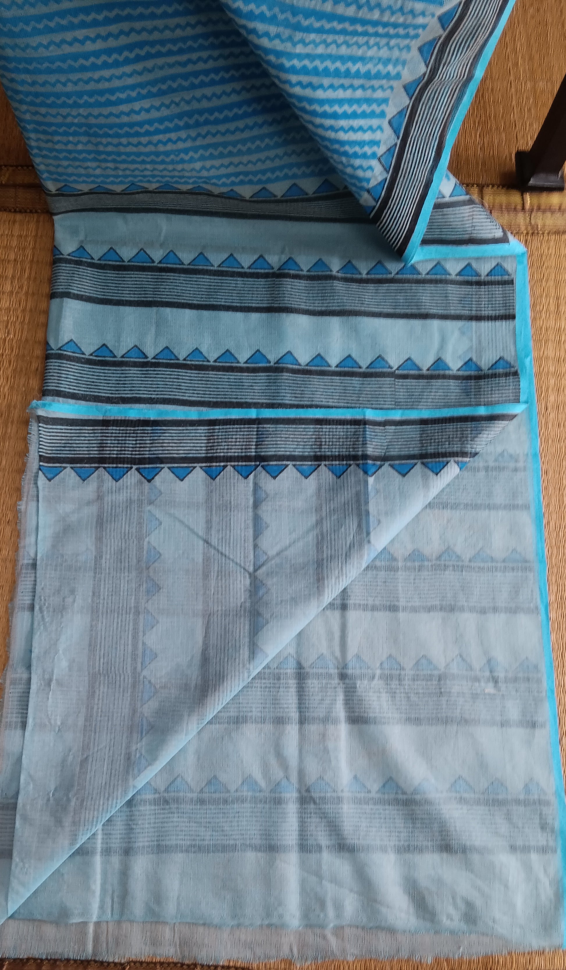 View from the top of the plain blue blouse of a daily wear kota cotton saree