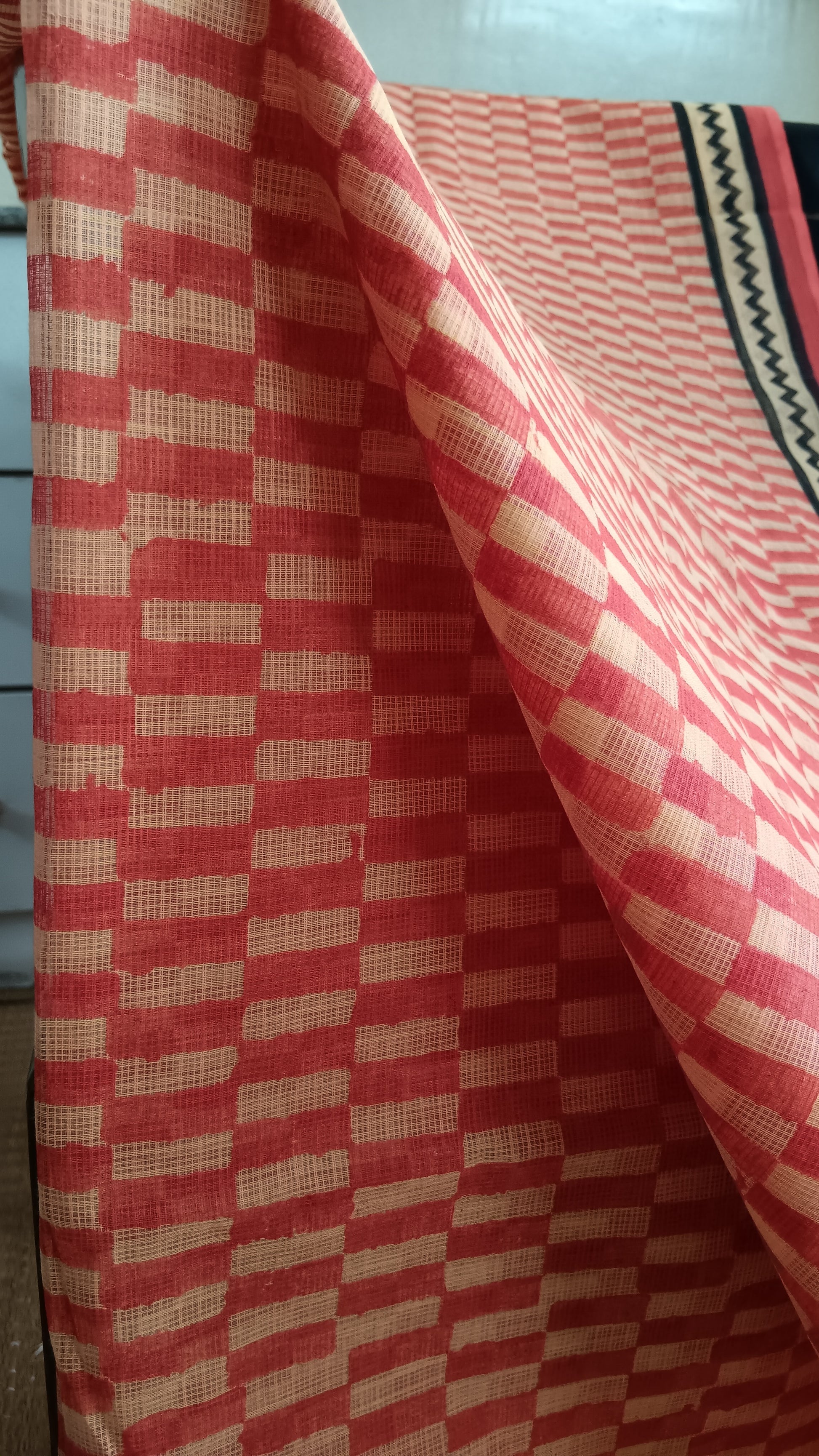 Close up view of the red checks block printed on the body of a daily wear kota cotton saree