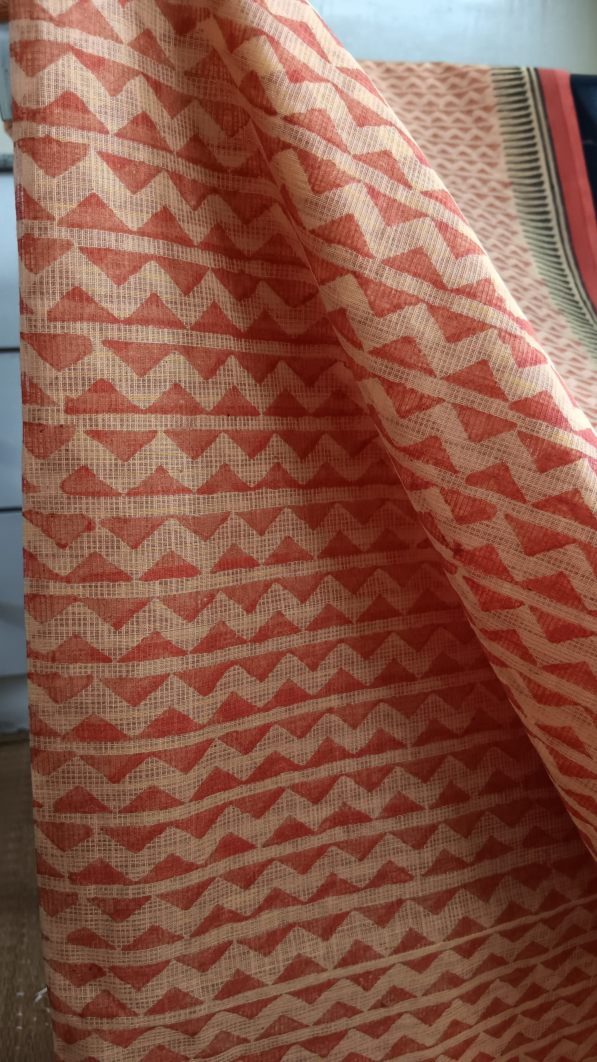 Close up view of the bold geometric pattern block printed on the body of a light weight kota cotton saree for daily use